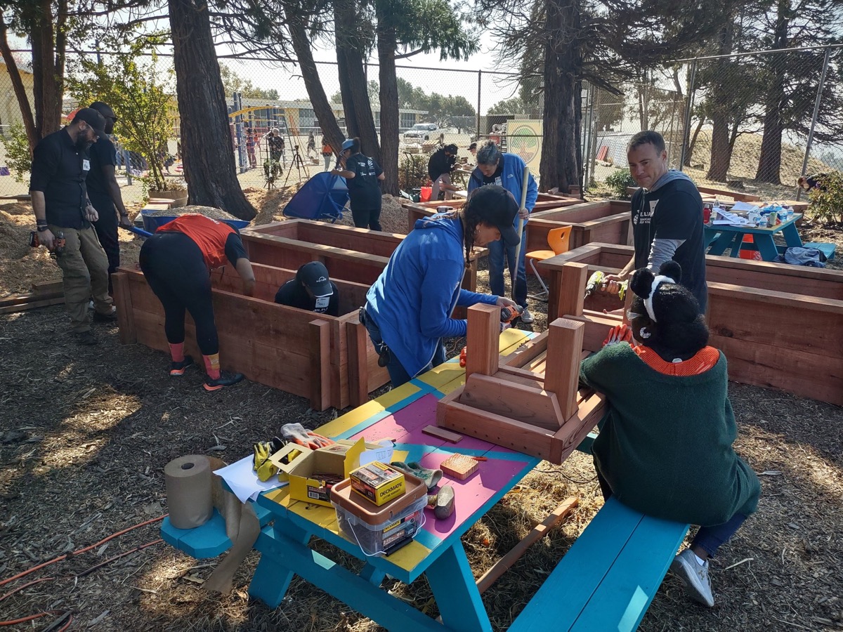 Families volunteer to revitalize playground at the Oakland Academy of Knowledge in Oakland, California. Courtesy of Oakland Unified School District.